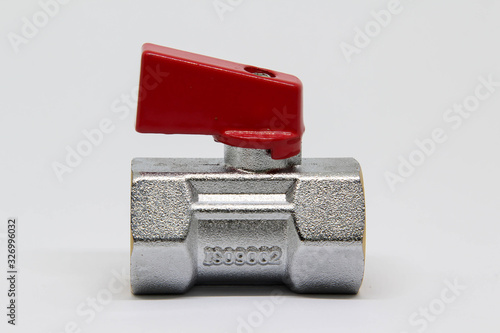 Brass ball valve with red handle on white background.