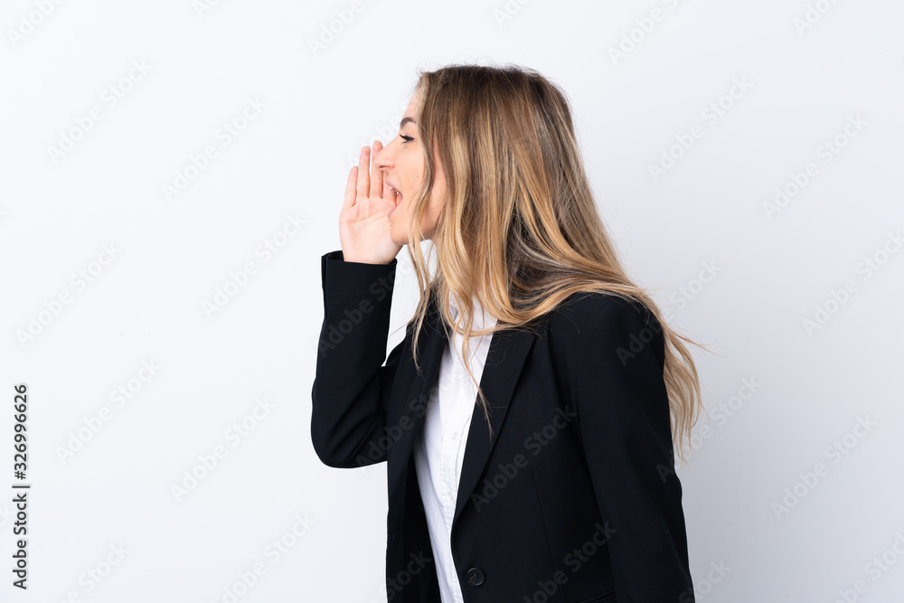 Young business woman over isolated white background shouting with mouth wide open Young business woman over isolated white background shouting with mouth wide open