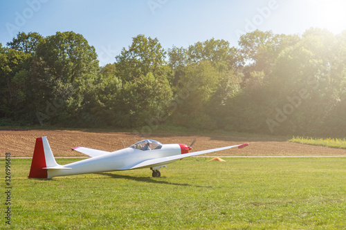 a small light-engine plane accelerates through the lelen field before takeoff