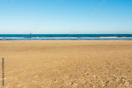 Valencia Beach  Malvarrosa  at noon with boats in the background