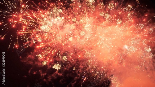 White and red fireworks display on dark sky background. Brightly colorful fireworks on twilight background