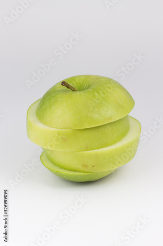 Top View and closed up isolate sliced green apple tower . Ripped healthy green fruit on white