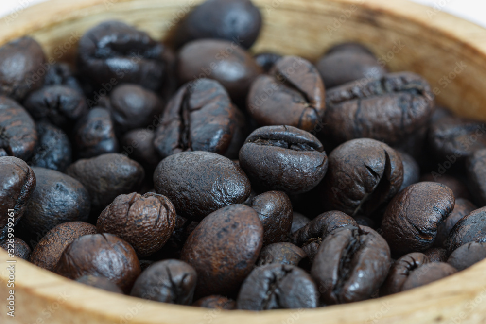 Roasted coffee beans in wood cup ,close up Roasted coffee beans in wood cup ,close up