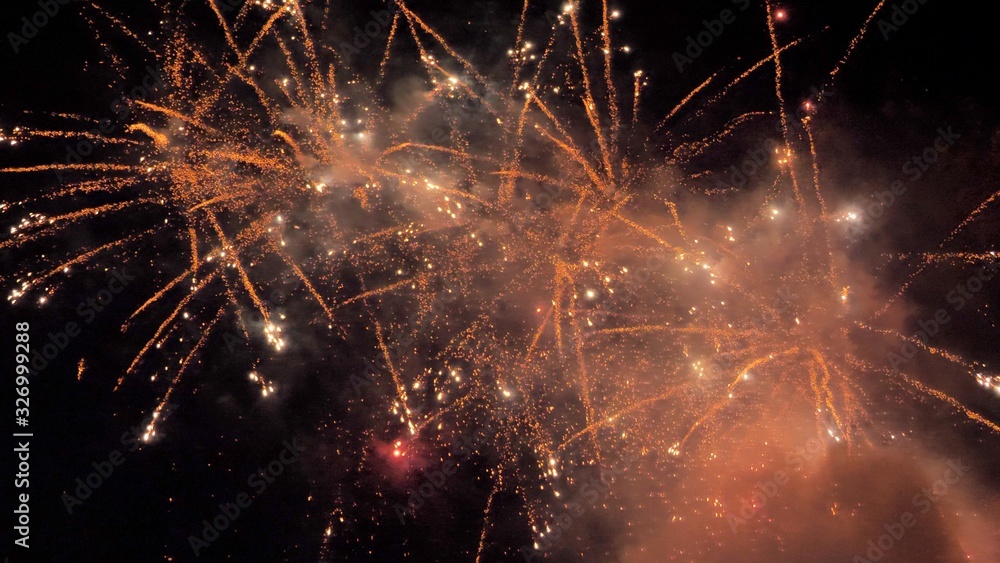 Fototapeta premium White and red fireworks display on dark sky background. Brightly colorful fireworks on twilight background