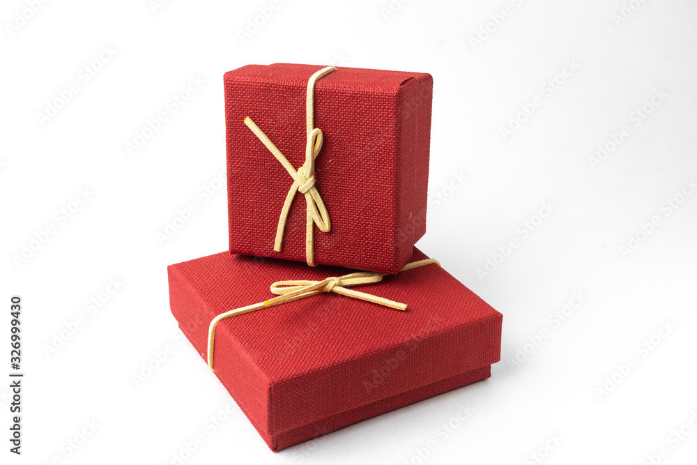 Surprise in flying boxes wrapped in red gift paper with bow on white background. Concept of holidays and greeting cards. Copy space. Surprise in flying boxes wrapped in red gift paper with bow on white background. Concept of holidays and greeting cards. Copy space.