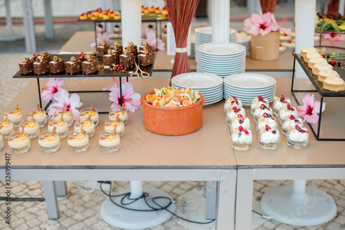 Wallpaper Mural The catering wedding buffet. Wedding reception dessert table with delicious decorated white cupcakes with berries closeup. Torontodigital.ca