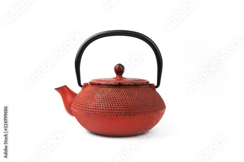 Red cast iron teapot on a white background. Asian culture.