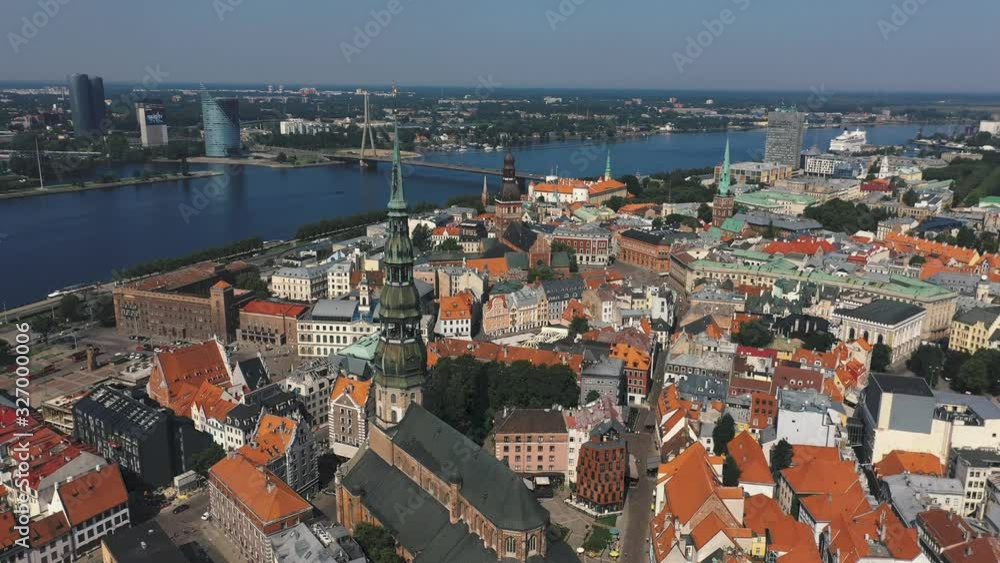 RIGA, LATVIA - MAY, 2019: Aerial drone view of the most famous spiers of the old city of Riga and the Daugava river. RIGA, LATVIA - MAY, 2019: Aerial drone view of the most famous spiers of the old city of Riga and the Daugava river.