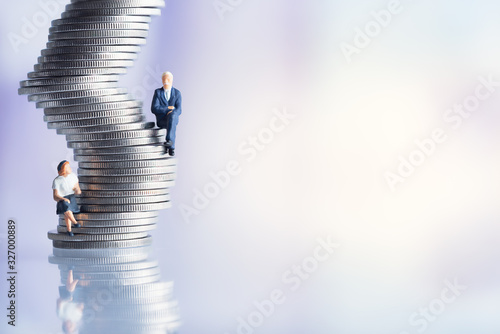 Miniature people: Elderly people sitting on coins stack. social security income and pensions. Money saving and Investment. Time counting down for retirement concept.