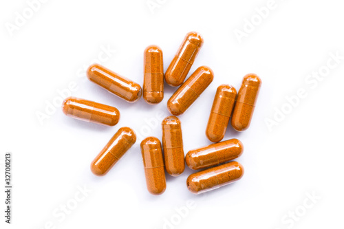 Turmeric capsules( known as curcumin, Curcuma , Tumeric) isolated on white background. Top view. Flat lay.