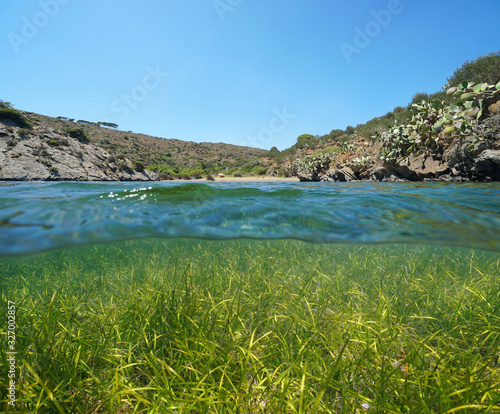 Peaceful Mediterranean cove with sea grass underwater, split view over and under water surface, Spain, Costa Brava, Cap de Creus, Cadaques, Cala Jonquet, Catalonia photo