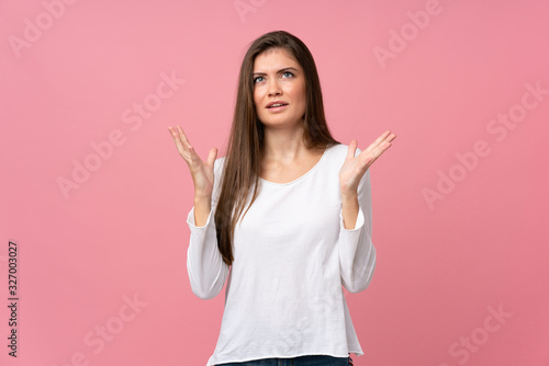 Young woman over isolated pink background frustrated by a bad situation © luismolinero