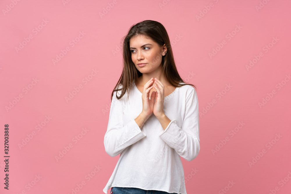 Young woman over isolated pink background scheming something Young woman over isolated pink background scheming something