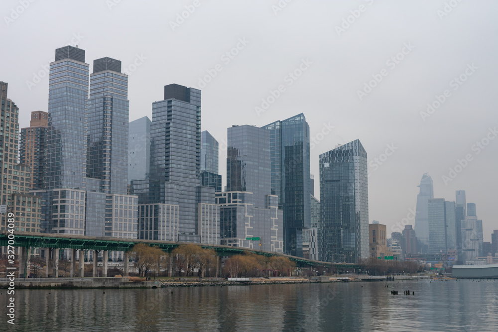 Obraz premium Modern Glass Skyscrapers in the Lincoln Square New York City Skyline along the Hudson River on a Foggy Day