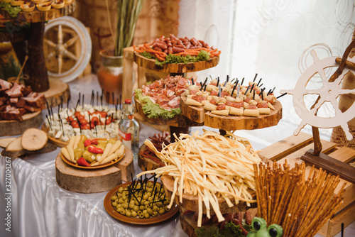 Meat and cheese appetizers. Antipasti and catering platter with different meat and cheese products. © Serhii