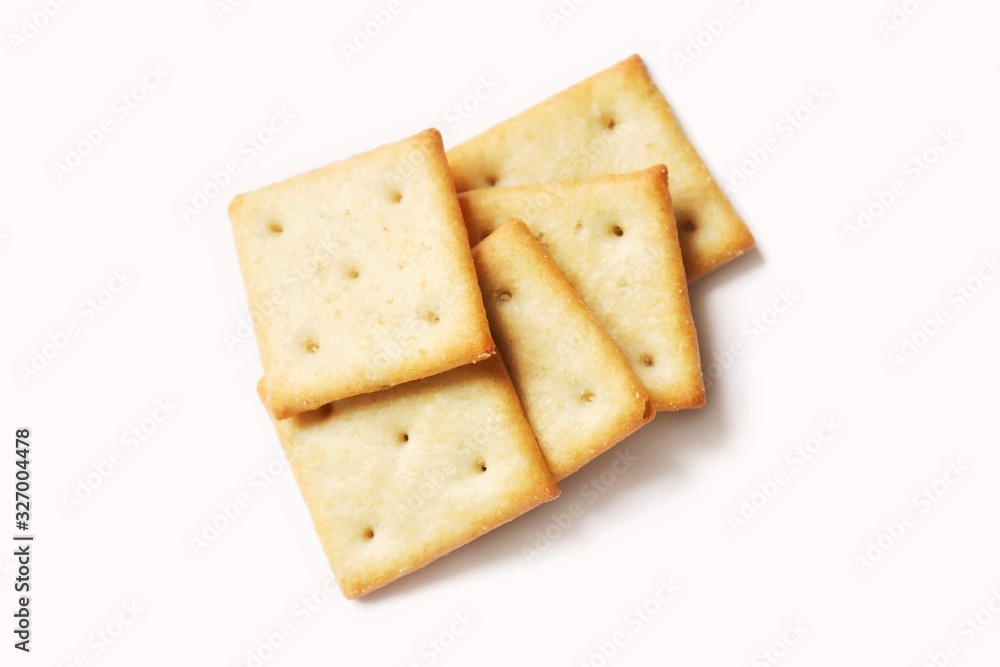 Square crispy saltine crackers isolated on white background. Flat lay food photography Square crispy saltine crackers isolated on white background. Flat lay food photography