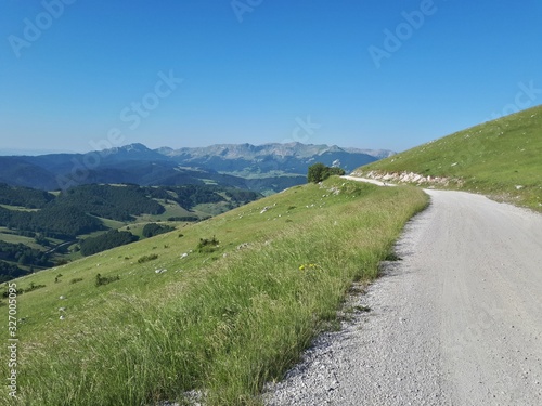 Rural road in the mountains with view of distant mountains