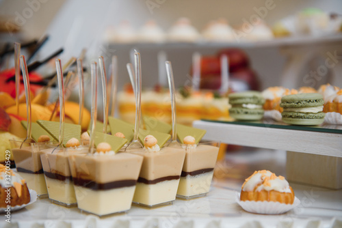 Delicious sweets on wedding candy buffet with desserts, cupcakes,tiramisu and cookies