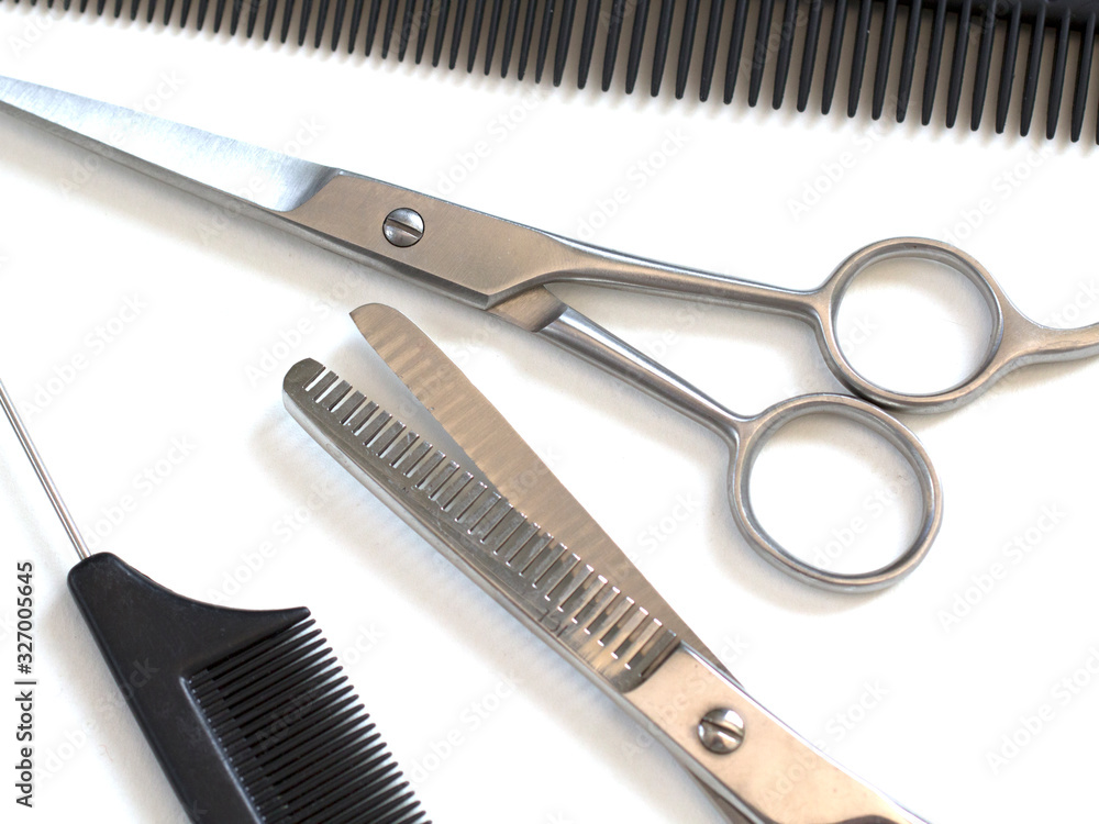hairdresser professional scissors and black hairbrush comb isolated on white background close up hairdresser professional scissors and black hairbrush comb isolated on white background close up