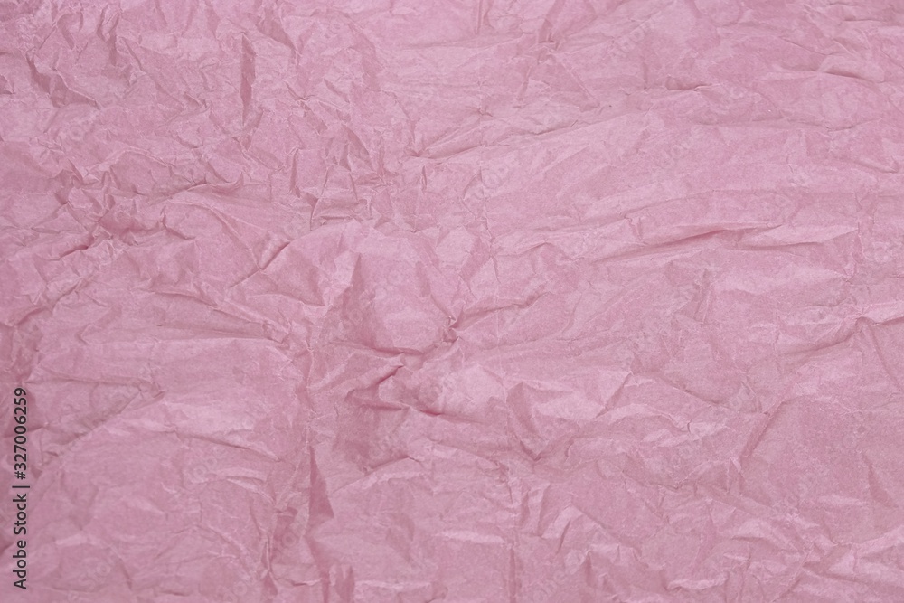 Crumpled pale pink tissue paper for background or gift wrapping. Abstract textured wrinkled faded rose parchment backdrop.Surface of bleached pink wrapping paper with creases texture for background. Crumpled pale pink tissue paper for background or gift wrapping. Abstract textured wrinkled faded rose parchment backdrop.Surface of bleached pink wrapping paper with creases texture for background.