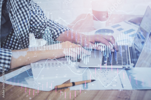 Multi exposure of stock market chart with man working on computer on background. Concept of financial analysis. © peshkova