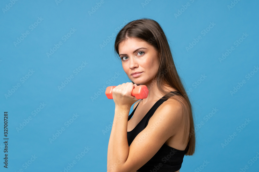 Young girl woman over isolated background making weightlifting Young girl woman over isolated background making weightlifting