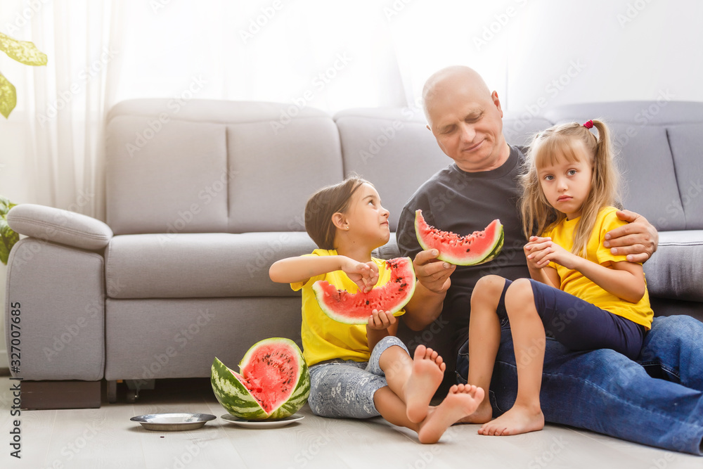 Two girls eating Watermelon isolated on home background Two girls eating Watermelon isolated on home background