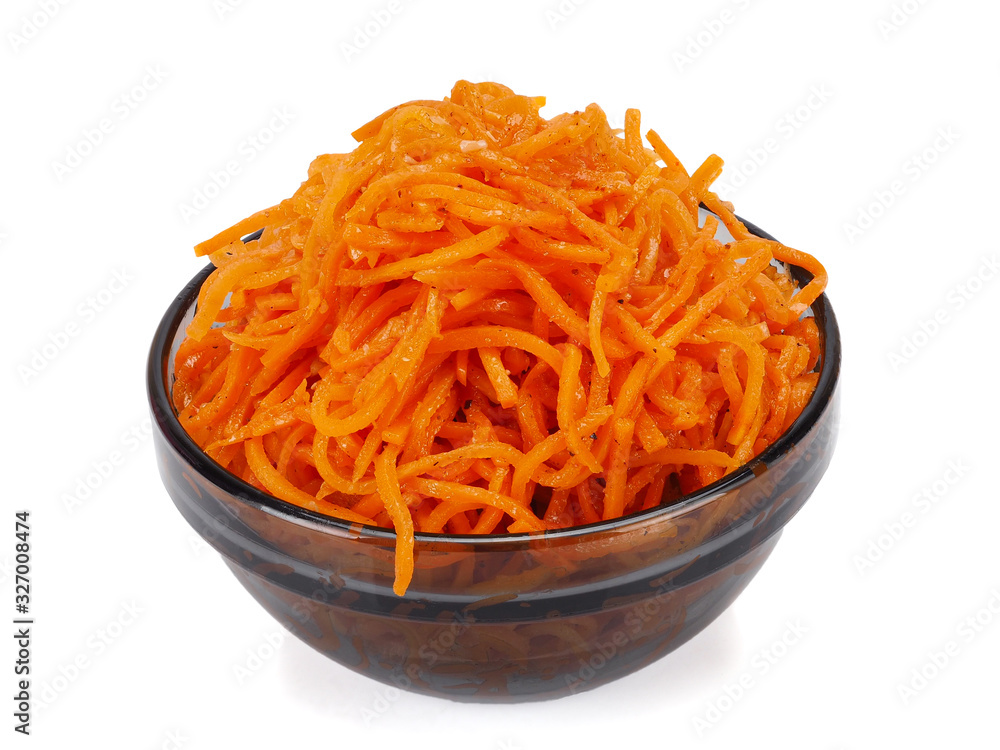 Korean carrot in a glass plate close-up on a white. Isolated. Korean carrot in a glass plate close-up on a white. Isolated.