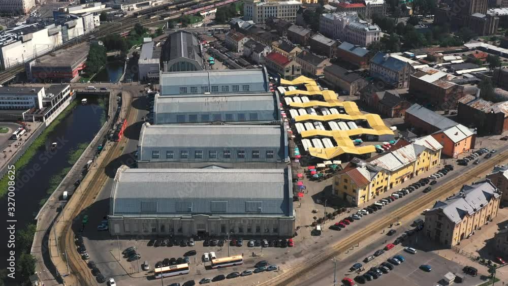 RIGA, LATVIA - MAY, 2019: Aerial drone view of the central market with many pavilions near historical centre of Riga. RIGA, LATVIA - MAY, 2019: Aerial drone view of the central market with many pavilions near historical centre of Riga.