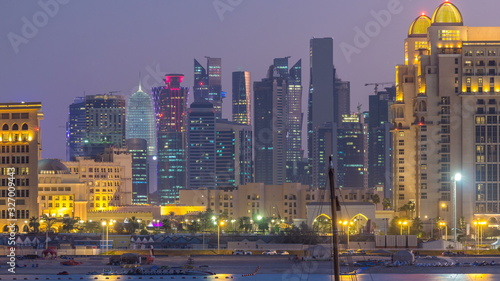 View from Katara Beach day to night timelapse in Doha  Qatar  towards the West Bay and city center