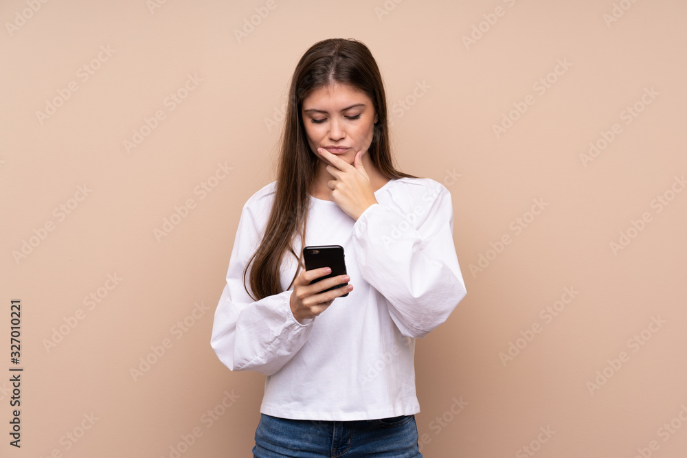 Young girl over isolated background thinking and sending a message Young girl over isolated background thinking and sending a message