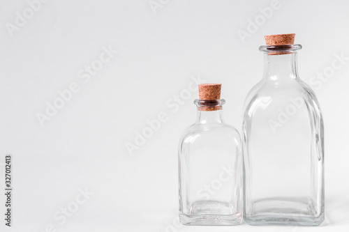 Glass bottles with cork on a white background