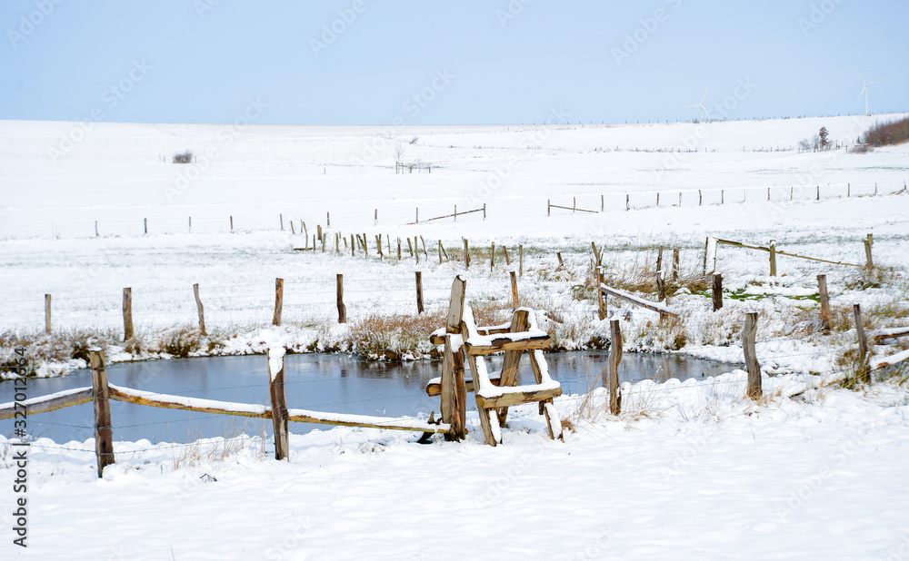 winter landscape with pond, wooden fence and blue sky winter landscape with pond, wooden fence and blue sky
