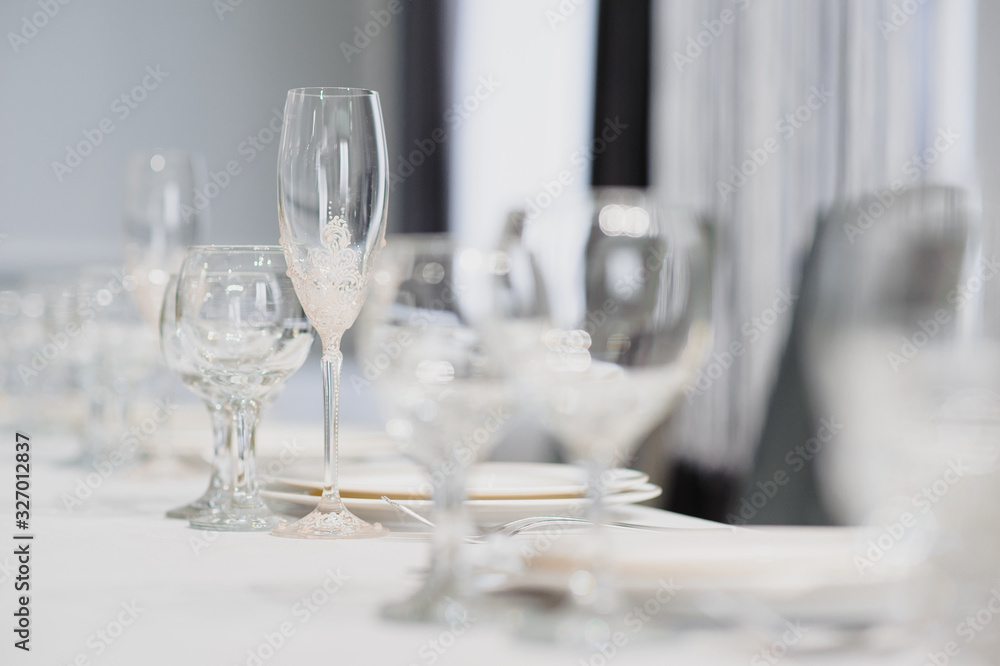 Glasses on the festive table setting. Wedding table decor concept. Table setting in classic style, setout. fine art. Glasses on the festive table setting. Wedding table decor concept. Table setting in classic style, setout. fine art.