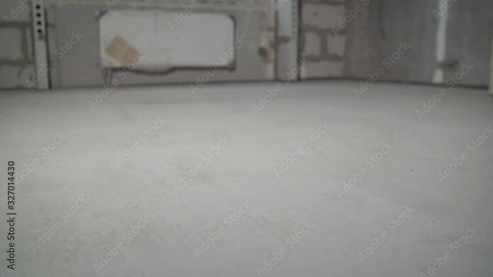 Priming the floor. Primer and concrete floor. The primer from the