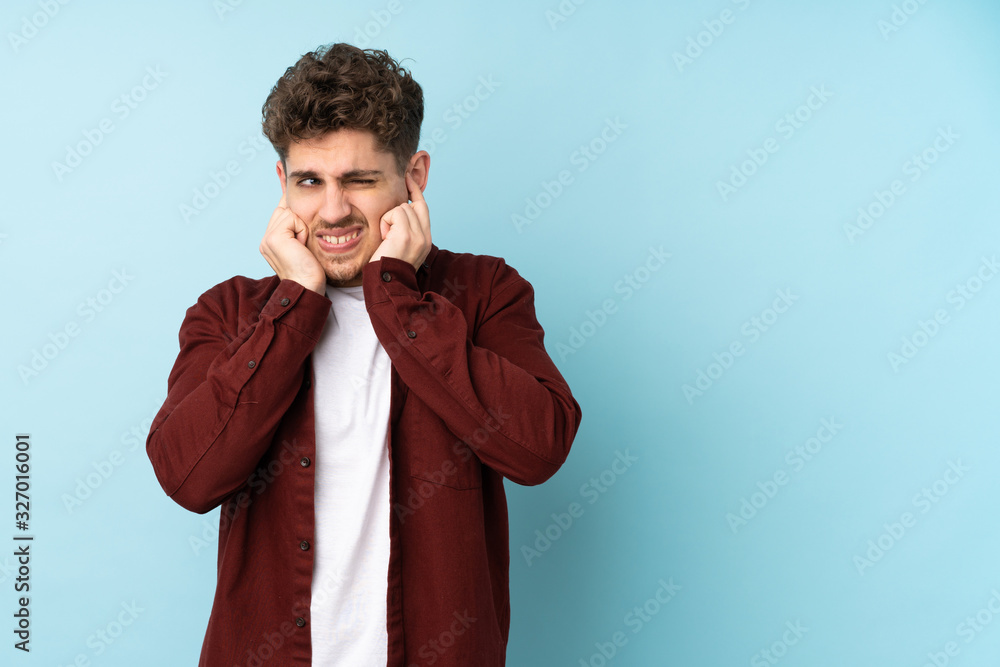 Young caucasian man isolated background frustrated and covering ears
