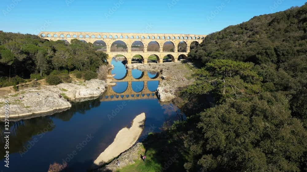 old bridge over the river Gardon Pont du gard perfect reflection aerial shot France