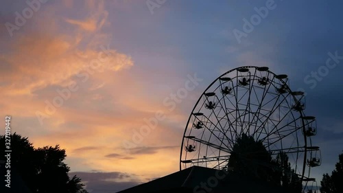 Ferris wheel on night damatic sky, don't move. Beautiful sunst time. photo