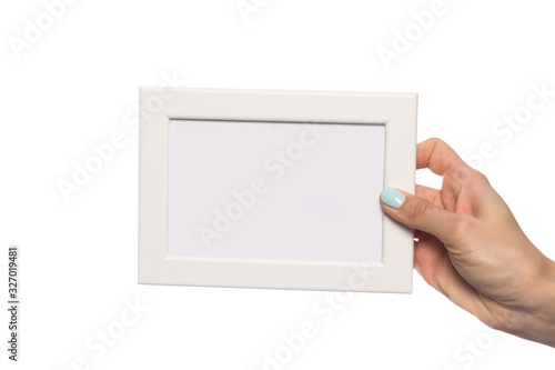 beautiful female hand holds a frame for a photo with an empty place for an inscription. isolated on a white background. mock up