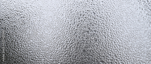 abstract gray texture of condensed mist on a cold glass