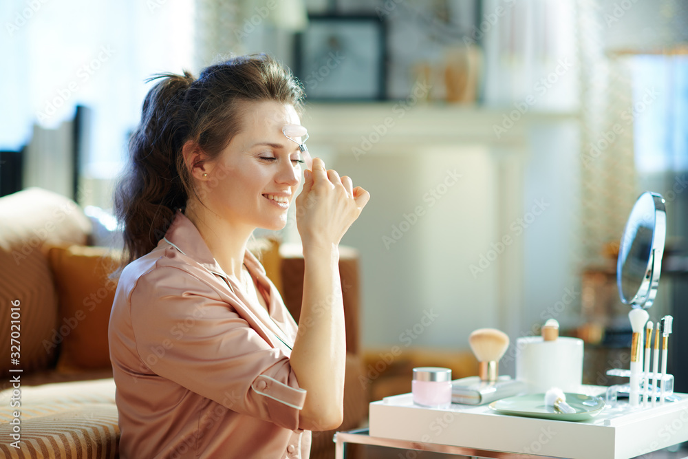 happy woman using calming quartz roller massager happy woman using calming quartz roller massager