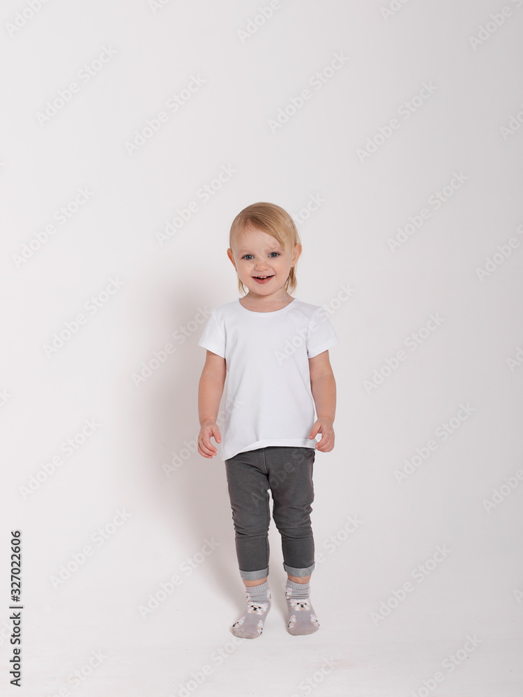 Baby girl in a white shirt on a white background Baby girl in a white shirt on a white background
