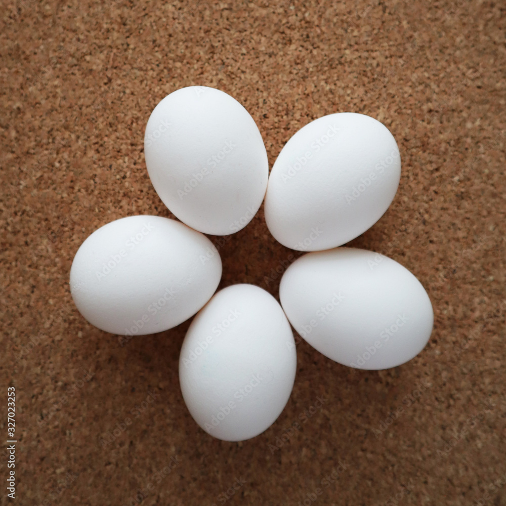 White eggs lie on the table in the form of a flower. Happy easter concept, top view. White eggs lie on the table in the form of a flower. Happy easter concept, top view.