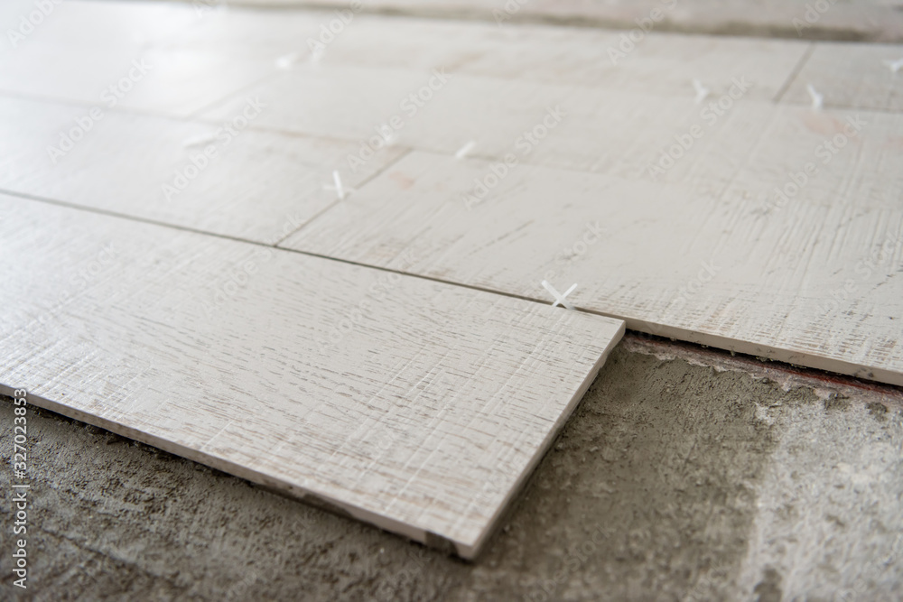 Ceramic wood effect tiles and tools for tiler on the floor Ceramic wood effect tiles and tools for tiler on the floor