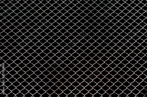 Steel mesh wire fence isolated on black background with clipping path
