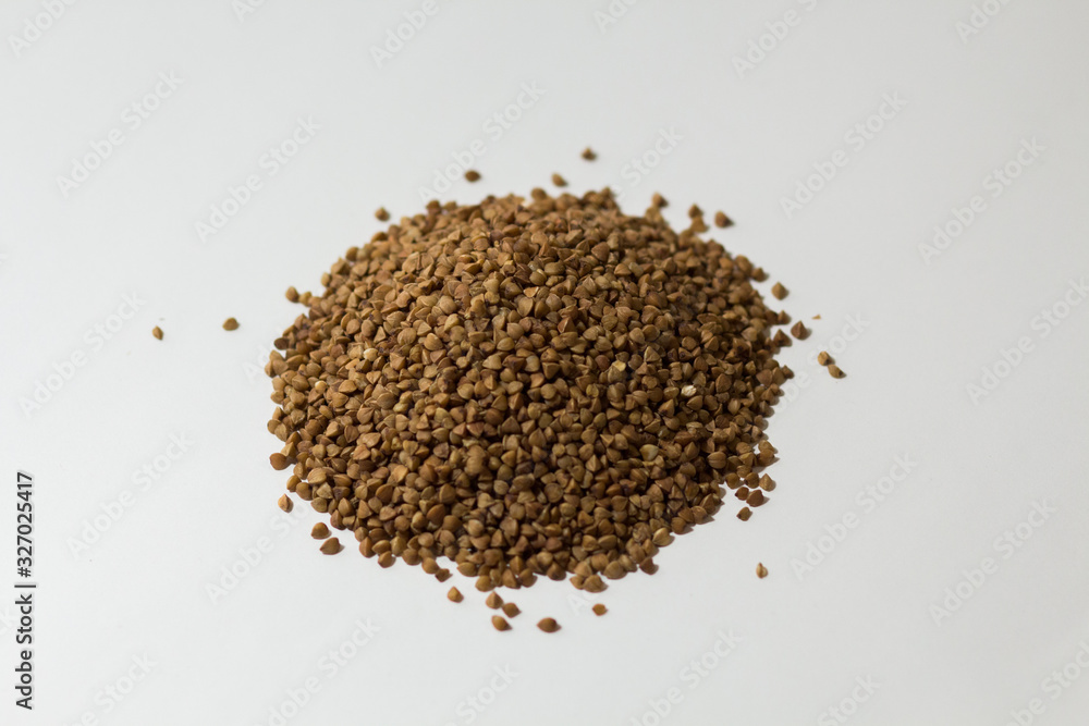 heap of buckwheat on a white background heap of buckwheat on a white background