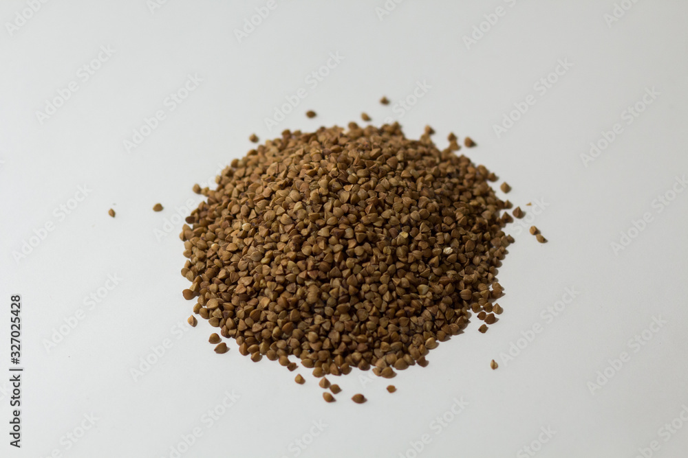 heap of buckwheat on a white background heap of buckwheat on a white background