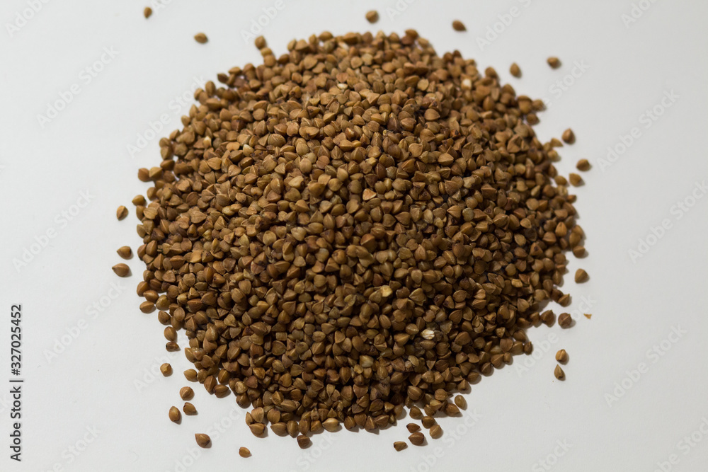 heap of buckwheat on a white background heap of buckwheat on a white background