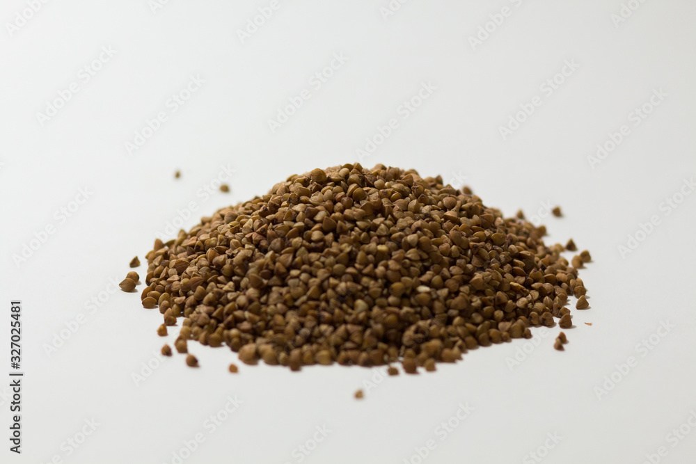 heap of buckwheat on a white background heap of buckwheat on a white background