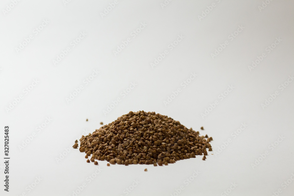 heap of buckwheat on a white background heap of buckwheat on a white background